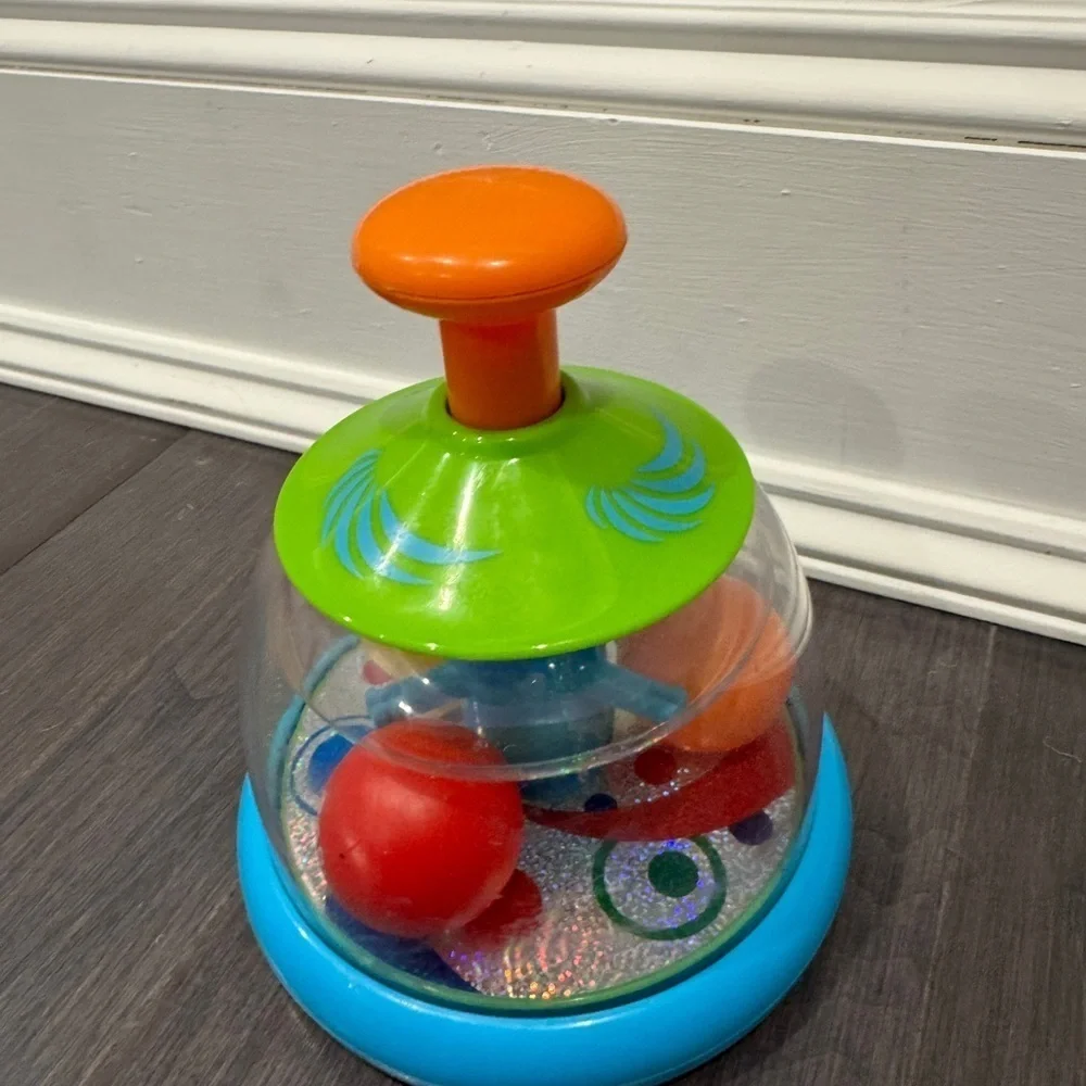Orange and Green Press and Spin Learning Baby Toy